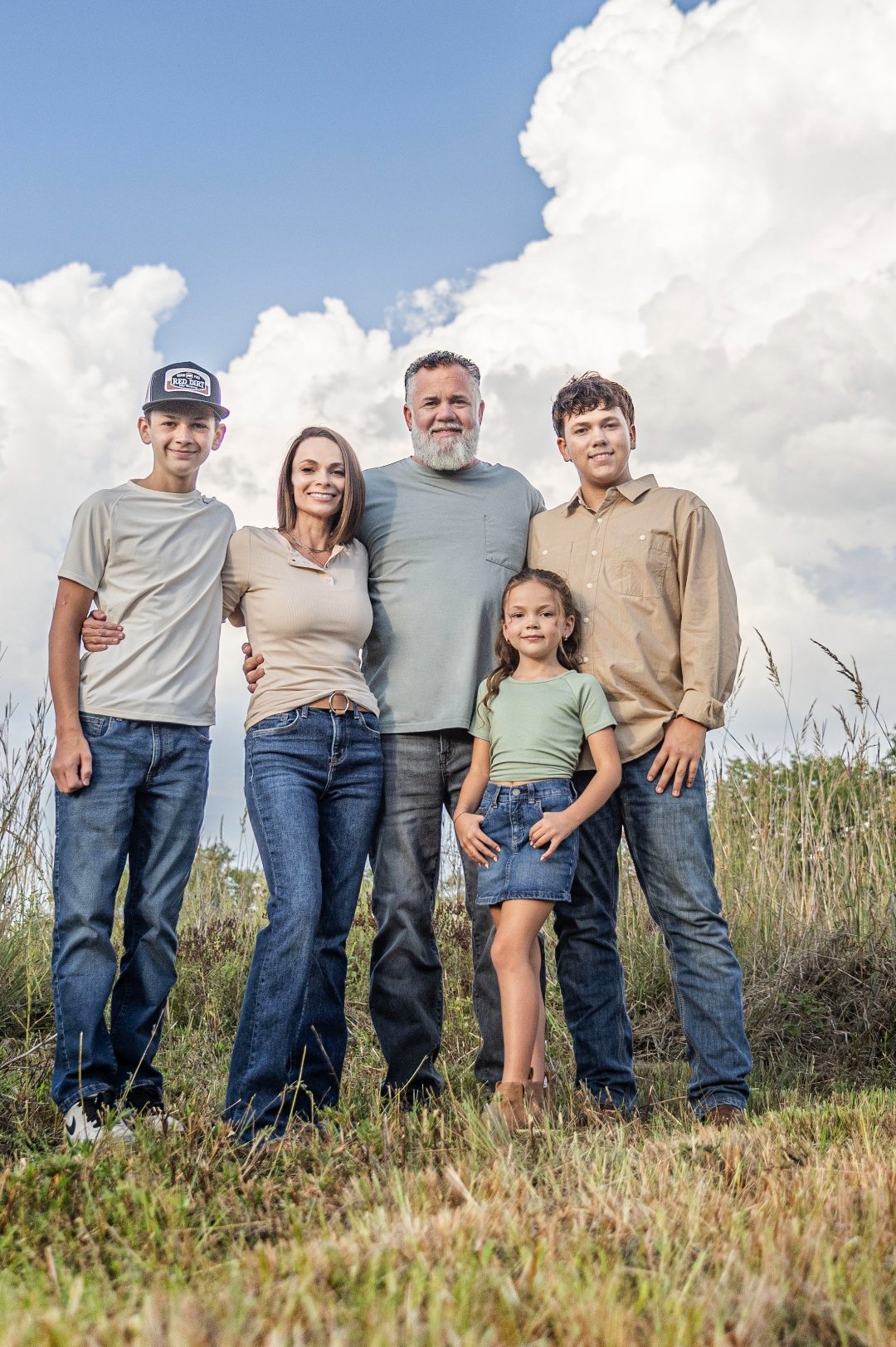 Josh and Cindy with their three kids in a field outside Lincoln